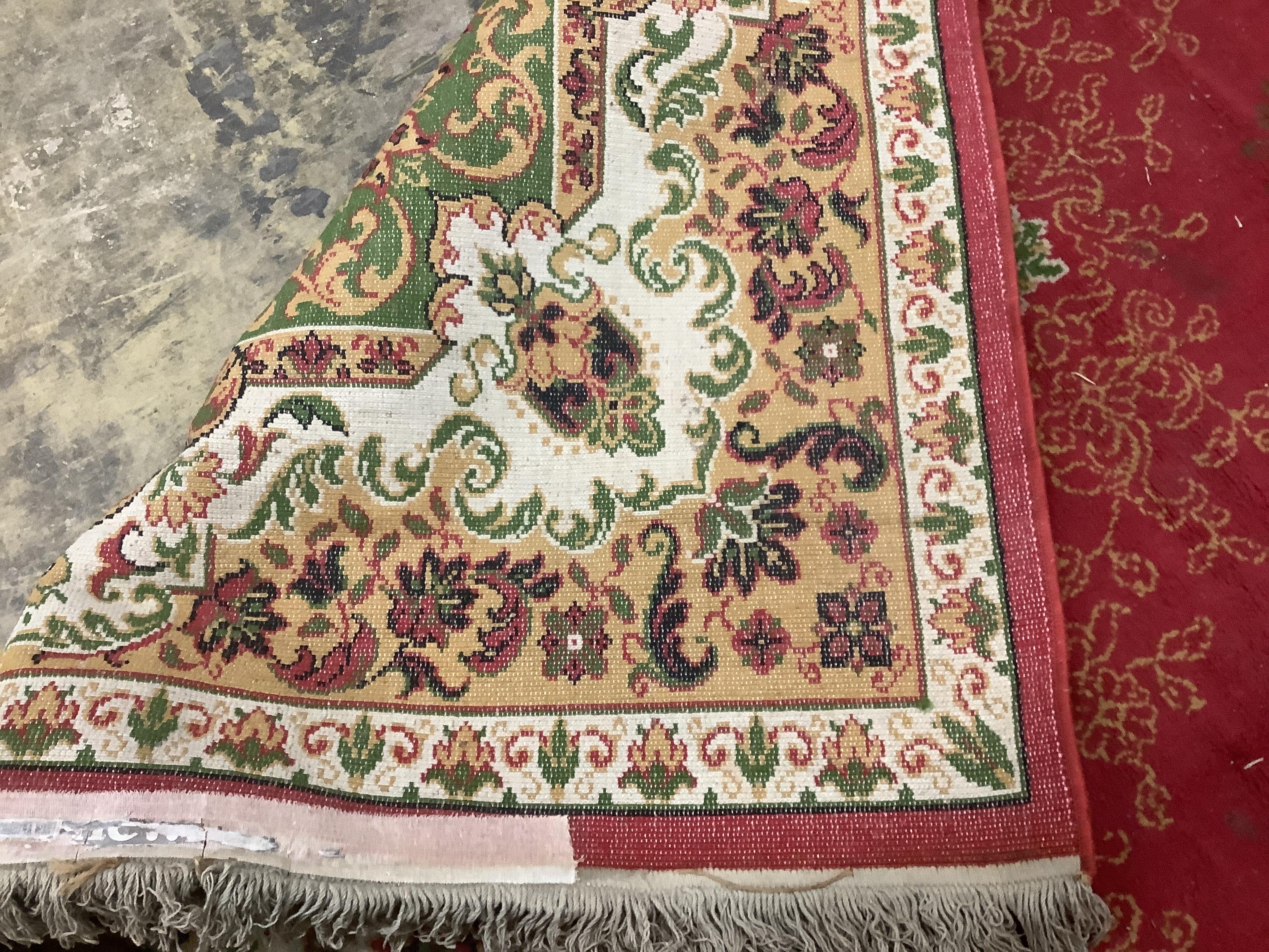 An Indian style machined red ground carpet, approx. 440 x 290cm